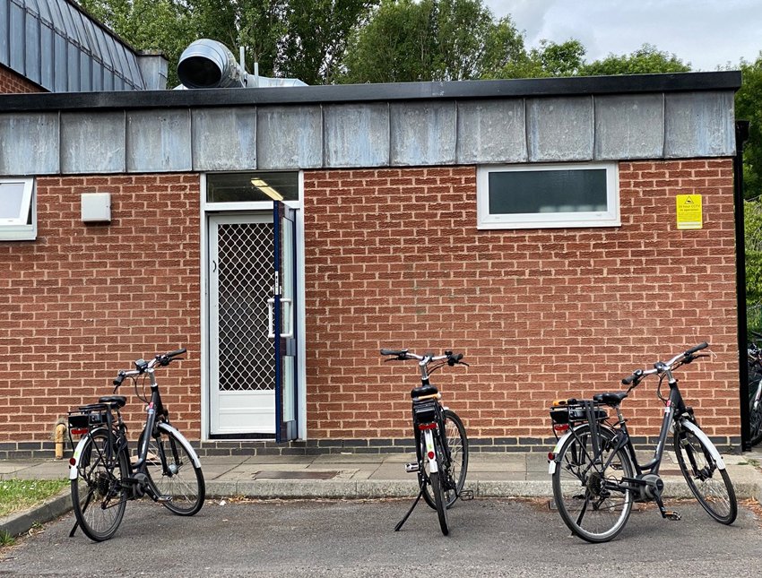 Three bikes belonging to dinner ladies parked outside the school where they work