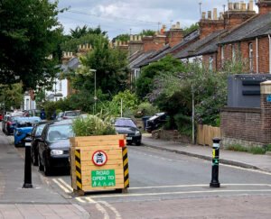 Local traffic neighbourhood with planter and bollard closing off residential street to cars