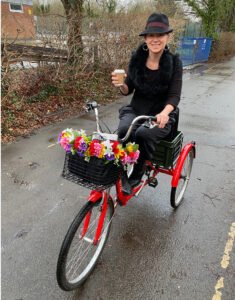 Emily Kerr riding an adult tricycle