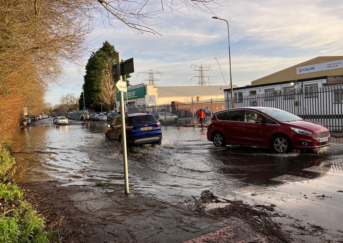 Cars driving through flood water in Feryy Hinksey Road Oxford